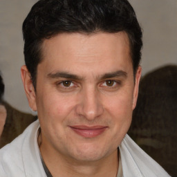 Joyful white adult male with short  brown hair and brown eyes