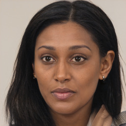 Joyful asian young-adult female with long  brown hair and brown eyes