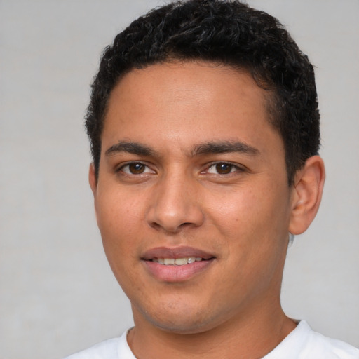 Joyful white young-adult male with short  black hair and brown eyes