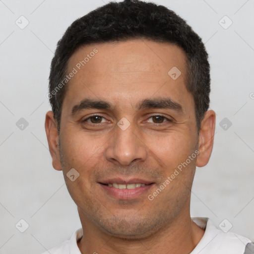 Joyful white young-adult male with short  black hair and brown eyes