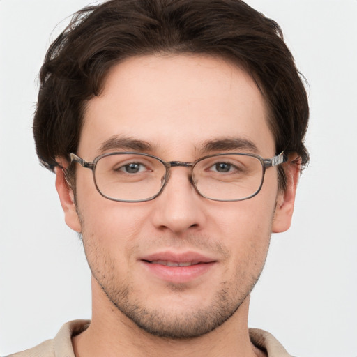 Joyful white young-adult male with short  brown hair and grey eyes