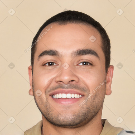 Joyful white young-adult male with short  black hair and brown eyes