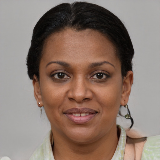 Joyful black adult female with short  brown hair and brown eyes