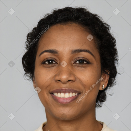 Joyful black young-adult female with long  black hair and brown eyes