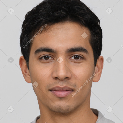 Joyful latino young-adult male with short  black hair and brown eyes