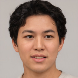 Joyful asian young-adult male with short  brown hair and brown eyes