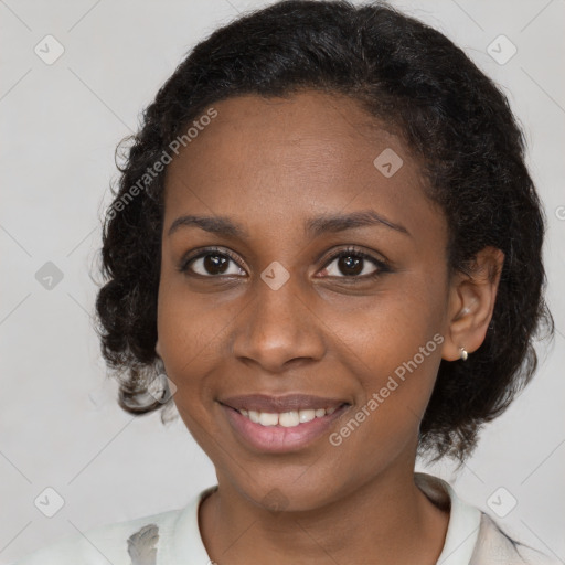 Joyful black young-adult female with medium  brown hair and brown eyes