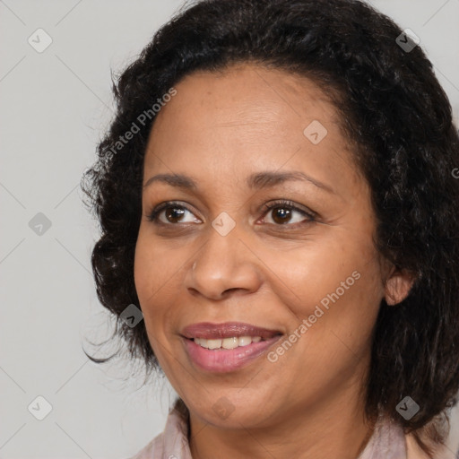 Joyful black adult female with medium  brown hair and brown eyes