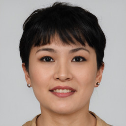 Joyful asian young-adult female with short  brown hair and brown eyes