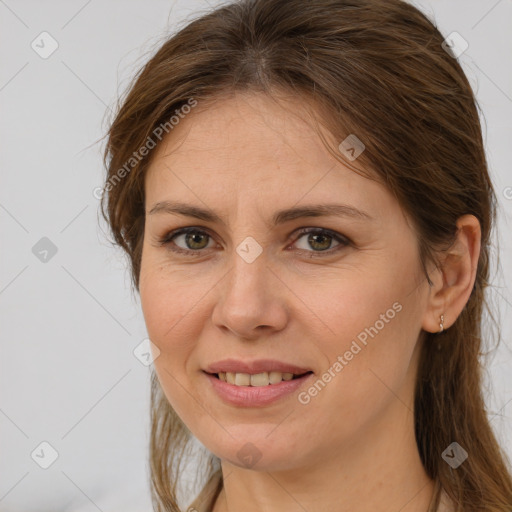 Joyful white adult female with long  brown hair and brown eyes