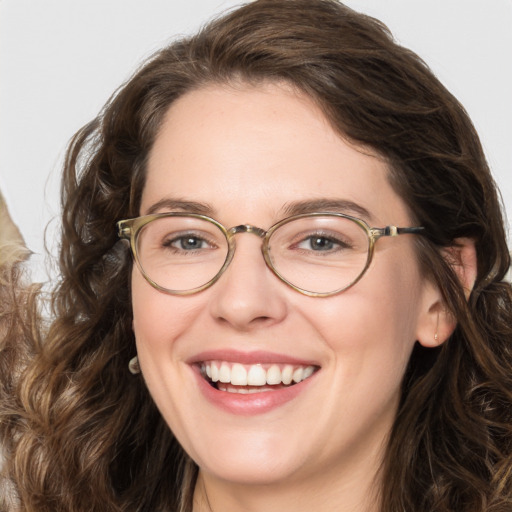 Joyful white adult female with long  brown hair and green eyes