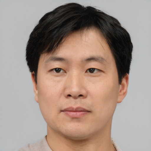 Neutral asian adult male with short  black hair and brown eyes