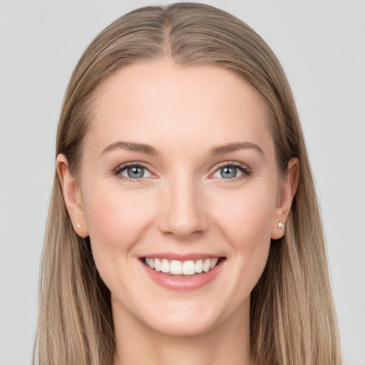 Joyful white young-adult female with long  brown hair and grey eyes