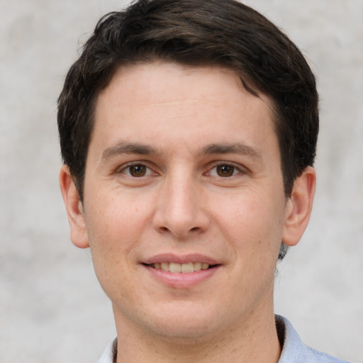 Joyful white young-adult male with short  brown hair and grey eyes