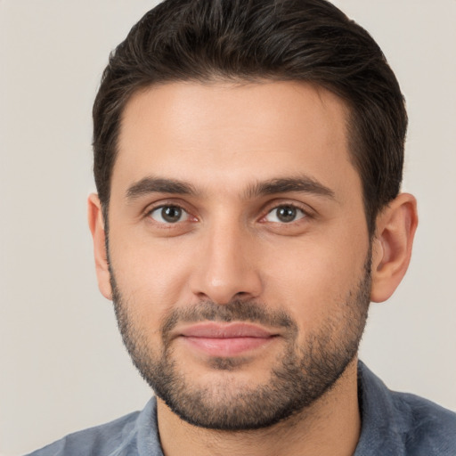 Joyful white young-adult male with short  brown hair and brown eyes