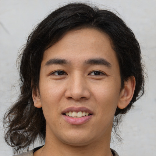 Joyful latino young-adult male with medium  brown hair and brown eyes