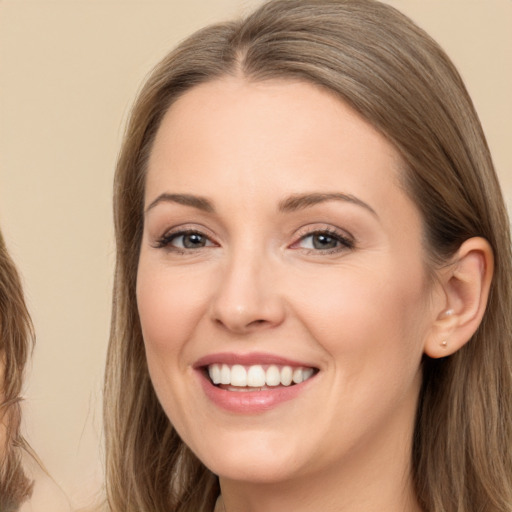 Joyful white young-adult female with long  brown hair and brown eyes