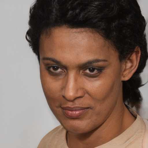 Joyful latino adult female with short  brown hair and brown eyes