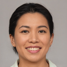 Joyful asian young-adult female with medium  brown hair and brown eyes