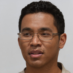 Joyful black adult male with short  black hair and brown eyes
