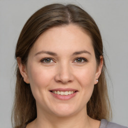 Joyful white young-adult female with medium  brown hair and grey eyes