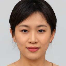 Joyful asian young-adult female with medium  brown hair and brown eyes