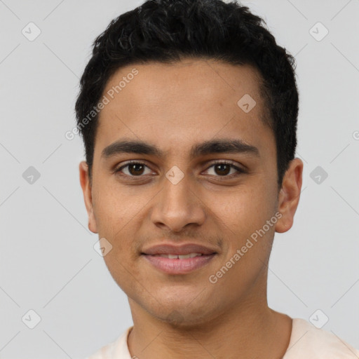 Joyful latino young-adult male with short  black hair and brown eyes