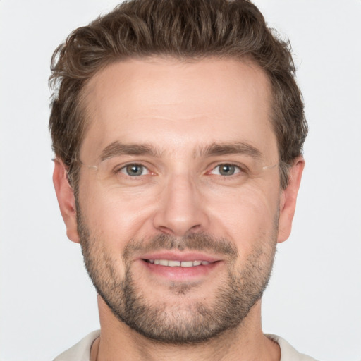 Joyful white adult male with short  brown hair and grey eyes