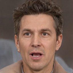 Joyful white adult male with short  brown hair and brown eyes