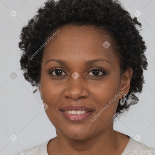 Joyful black adult female with short  brown hair and brown eyes