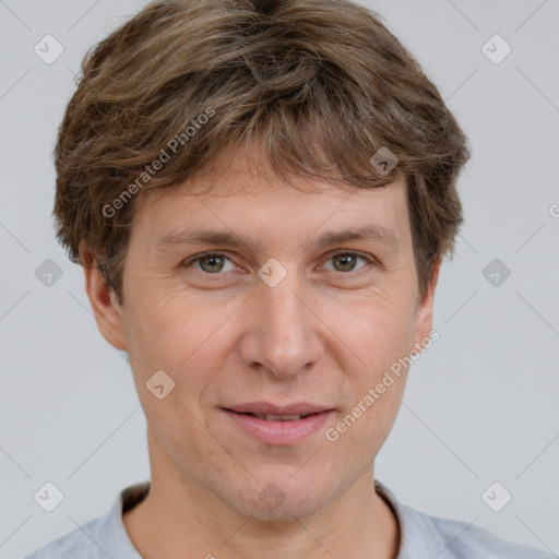 Joyful white adult male with short  brown hair and grey eyes