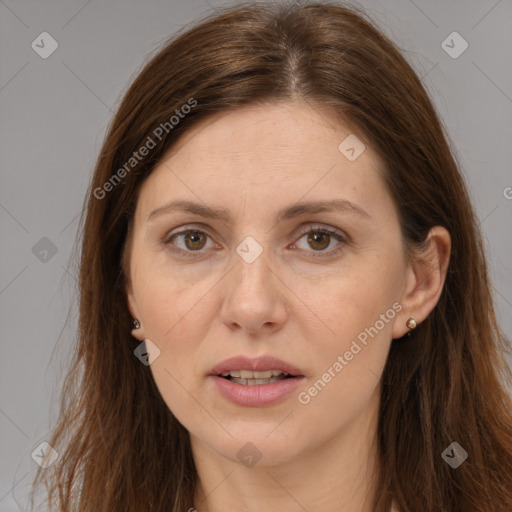 Joyful white adult female with long  brown hair and brown eyes