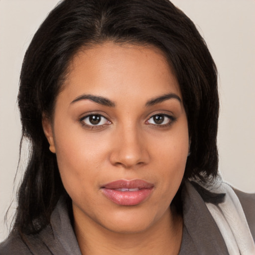 Joyful latino young-adult female with medium  brown hair and brown eyes