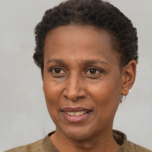 Joyful black adult female with short  brown hair and brown eyes