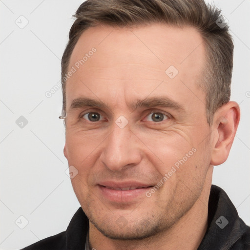 Joyful white adult male with short  brown hair and brown eyes