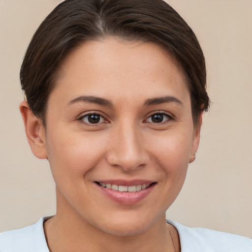 Joyful white young-adult female with short  brown hair and brown eyes