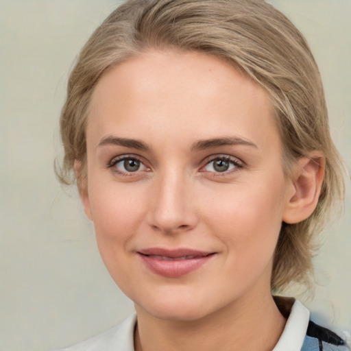 Joyful white young-adult female with medium  brown hair and blue eyes