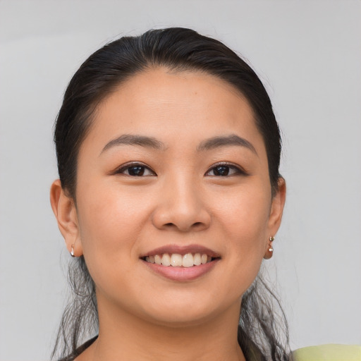 Joyful asian young-adult female with medium  brown hair and brown eyes
