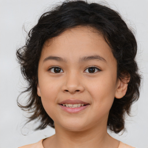 Joyful latino child female with medium  brown hair and brown eyes