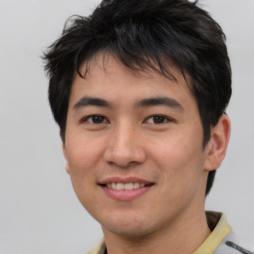 Joyful asian young-adult male with short  brown hair and brown eyes