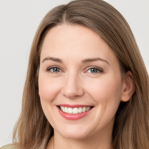 Joyful white young-adult female with long  brown hair and grey eyes