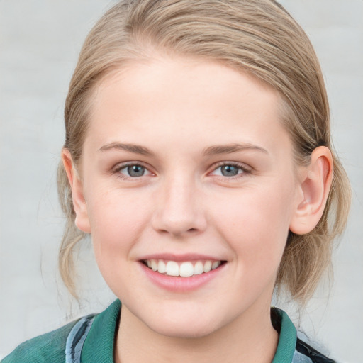 Joyful white young-adult female with medium  brown hair and blue eyes