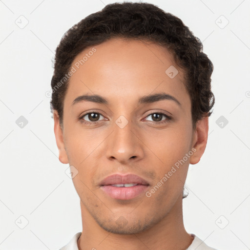 Joyful latino young-adult male with short  brown hair and brown eyes