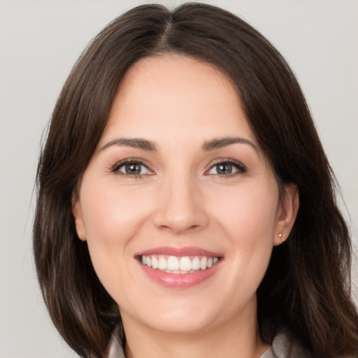 Joyful white young-adult female with medium  brown hair and brown eyes