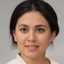 Joyful latino young-adult female with medium  brown hair and brown eyes