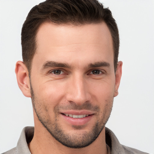 Joyful white young-adult male with short  brown hair and brown eyes