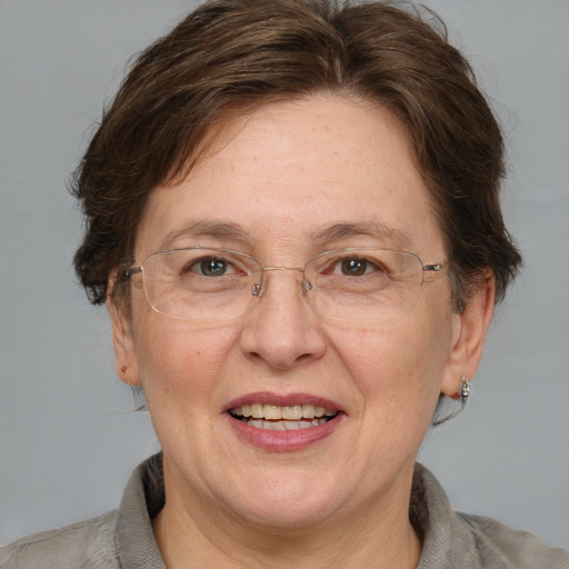 Joyful white middle-aged female with medium  brown hair and blue eyes