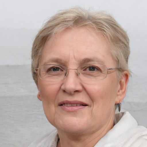 Joyful white middle-aged female with short  blond hair and blue eyes