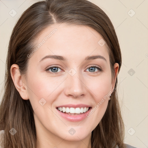 Joyful white young-adult female with long  brown hair and grey eyes