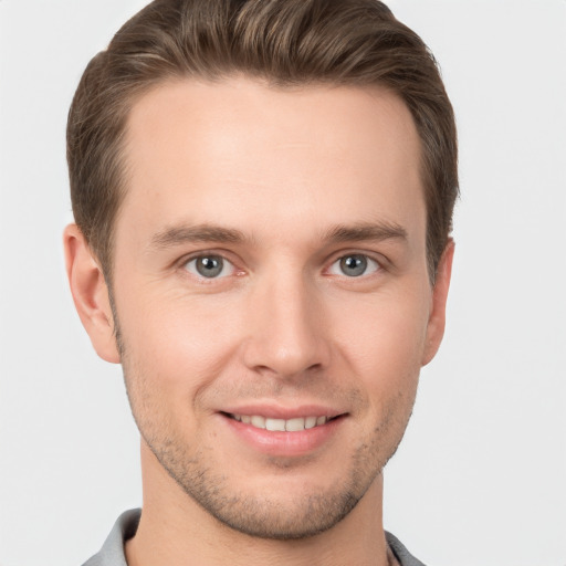 Joyful white young-adult male with short  brown hair and brown eyes